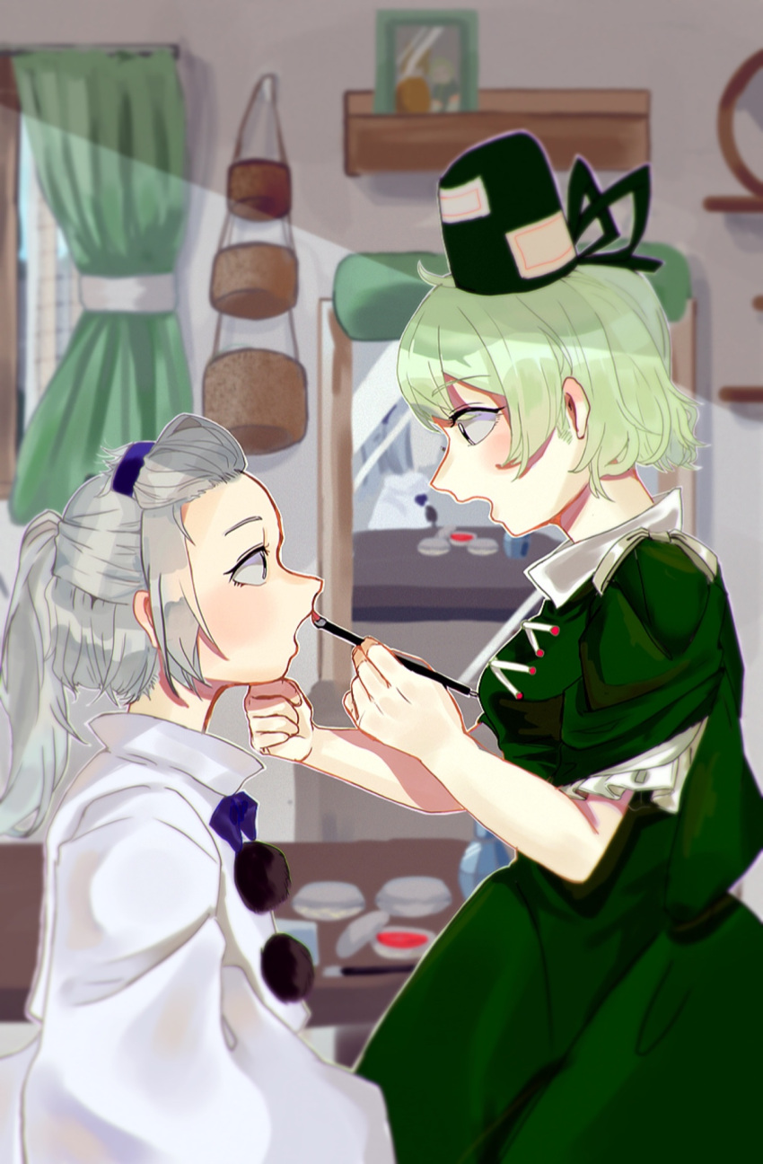 2girls applying_makeup bangs_pinned_back blurry blurry_background blush breasts cowboy_shot cross-laced_clothes dress from_side green_curtains green_dress green_eyes green_hair hand_on_another's_chin hat highres indoors japanese_clothes kariginu long_hair looking_at_another makeup mirror mononobe_no_futo multiple_girls no_hat no_headwear oishiinori_1248 pom_pom_(clothes) ponytail profile short_hair silver_hair sitting small_breasts soga_no_tojiko tate_eboshi touhou window