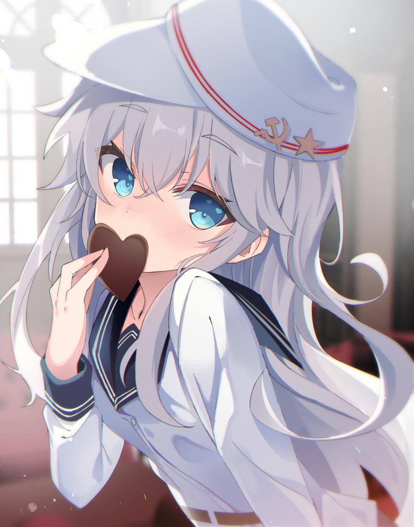 1girl absurdres black_sailor_collar blue_eyes blush buttons candy chocolate eyebrows_visible_through_hair fathom food hair_between_eyes hammer_and_sickle hat heart heart-shaped_chocolate hibiki_(kancolle) highres holding holding_chocolate holding_food kantai_collection long_hair long_sleeves looking_at_viewer sailor_collar sailor_shirt shirt silver_hair solo upper_body verniy_(kancolle) white_headwear white_shirt