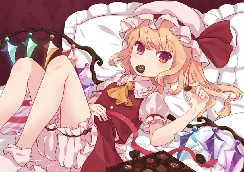 1girl ascot back_bow bangs blonde_hair bloomers blush bobby_socks bow box box_of_chocolates buttons candy chocolate collar commentary crystal eyebrows_visible_through_hair flandre_scarlet flat_chest food frilled_collar frills hand_on_own_stomach hat hat_bow heart heart-shaped_chocolate holding holding_chocolate holding_food looking_at_viewer lying mob_cap on_back on_bed pantylines pillow pink_ribbon puffy_short_sleeves puffy_sleeves rainbow_order red_eyes red_ribbon red_vest ribbon sash sawara_(starligtvision) short_hair short_sleeves slit_pupils socks solo touhou underwear upper_body vest white_headwear white_legwear white_sash wings yellow_ascot