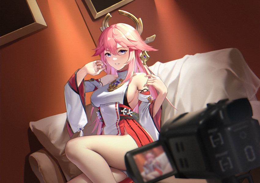 1girl bare_legs bare_shoulders blush breasts couch genshin_impact hair_between_eyes hair_ornament half-closed_eyes highres indoors japanese_clothes large_breasts legs long_hair long_sleeves looking_at_viewer miko on_couch parted_lips pink_hair sideboob sitting solo video_camera wide_sleeves yae_miko yin_lan_xue