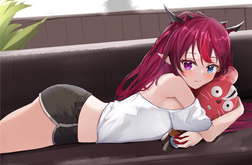 1girl backlighting bangs bare_shoulders black_shorts blue_eyes closed_mouth couch demon_girl demon_horns dolphin_shorts eyebrows_visible_through_hair from_side hakos_baelz hakos_baelz_(rat) heterochromia highres hololive hololive_english horns indoors irys_(hololive) looking_at_viewer looking_to_the_side lying object_hug off-shoulder_shirt off_shoulder on_couch on_stomach pointy_ears shirt short_sleeves shorts shuuzo3 smile solo stuffed_toy violet_eyes virtual_youtuber white_shirt
