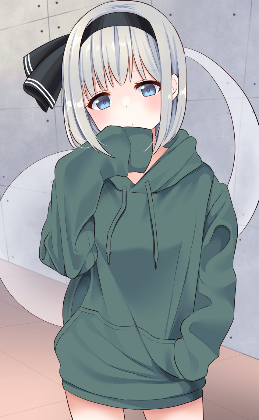 1girl absurdres alternate_costume bangs black_hairband black_ribbon blue_eyes blush breasts closed_mouth commentary_request eyebrows_visible_through_hair floor ghost green_hoodie grey_hair hairband hand_in_pocket hand_up highres hitodama hood hoodie konpaku_youmu konpaku_youmu_(ghost) long_sleeves looking_at_viewer medium_breasts no_pants puffy_long_sleeves puffy_sleeves ribbon short_hair solo standing stigma1101 touhou wall