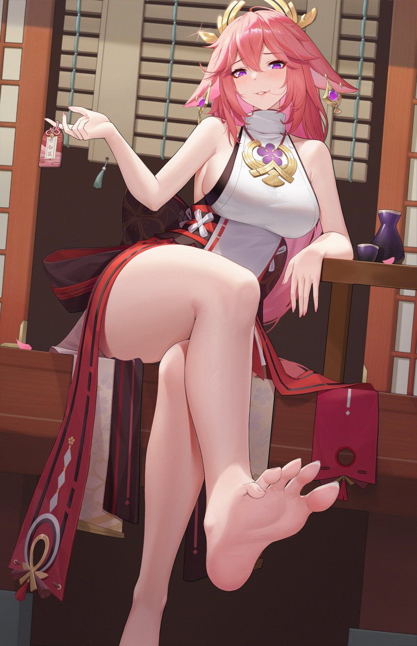 1girl absurdres animal_ears arm_rest bangs bare_shoulders barefoot blush bottle breasts charm_(object) choko_(cup) crossed_legs cup earrings eyebrows_visible_through_hair floppy_ears foot_out_of_frame fox_ears genshin_impact glint gold_earrings hair_between_eyes hair_ornament highres holding holding_charm japanese_clothes jewelry kurosara large_breasts long_hair looking_at_viewer obi parted_lips petals pink_hair pink_nails sake_bottle sash shirt sitting smile soles solo table tassel thighs violet_eyes white_shirt yae_miko