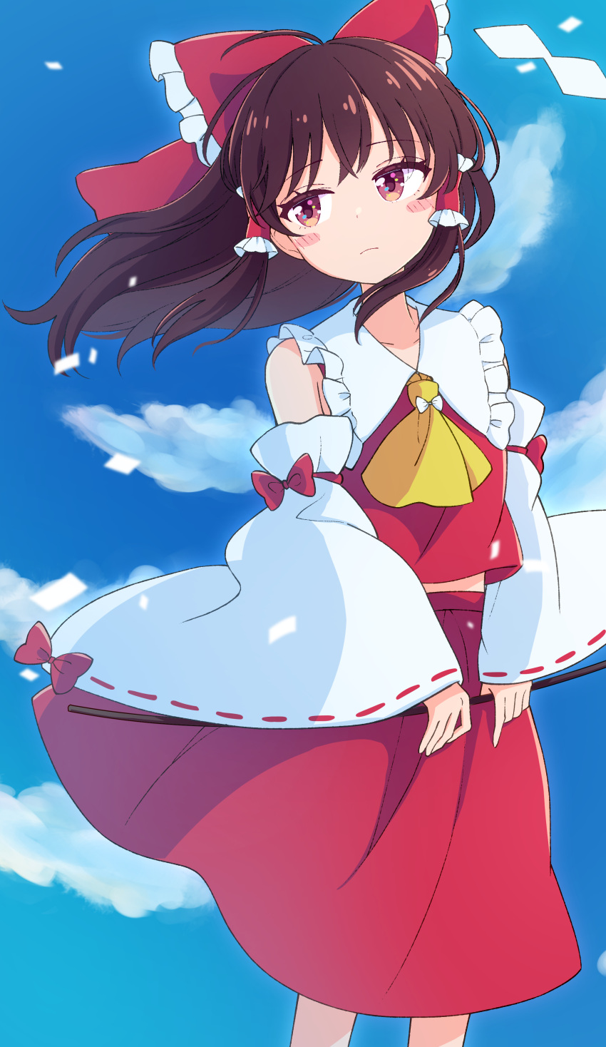1girl absurdres ascot blue_sky bow brown_hair clouds day detached_sleeves frills hair_bow hair_tubes hakurei_reimu haruki_reimari highres long_hair looking_at_viewer red_bow red_eyes red_skirt ribbon-trimmed_sleeves ribbon_trim sidelocks skirt skirt_set sky solo standing touhou wide_sleeves yellow_neckwear