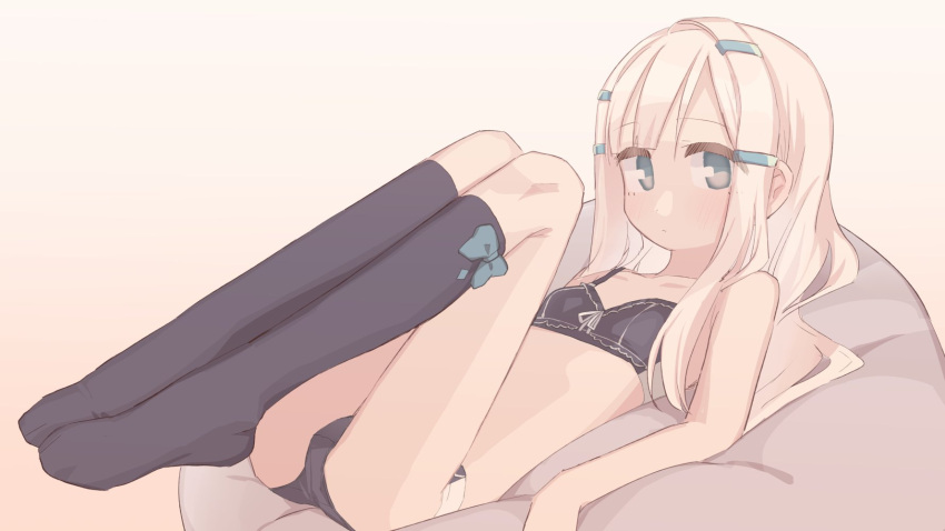 1girl blonde_hair blue_eyes blush bra cushion expressionless flat_chest full_body gradient gradient_background hair_ornament hairclip highres kneehighs legs_up long_hair looking_at_viewer lying on_back original panties solo underwear unomiki