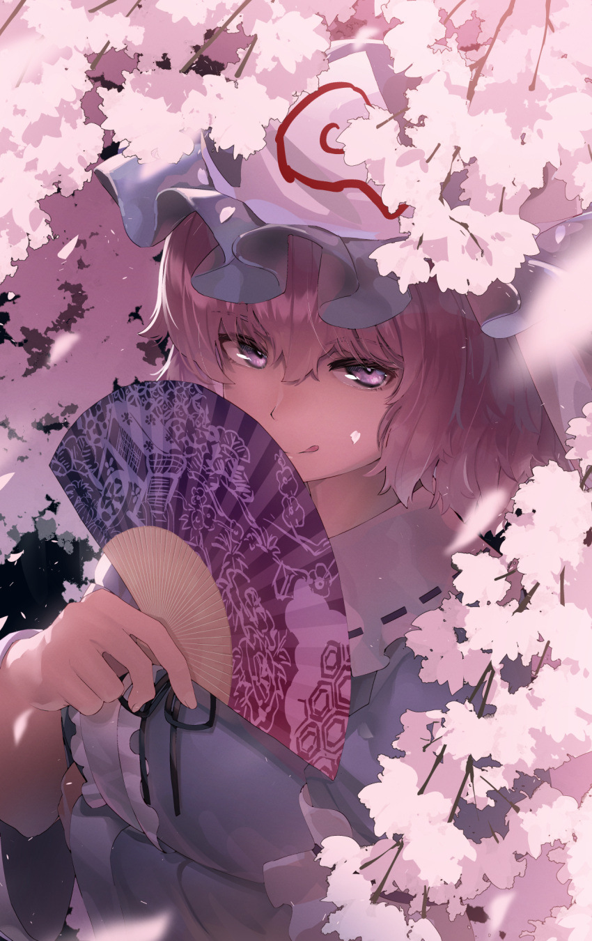 1girl :q arm_under_breasts bangs black_ribbon blue_headwear blue_kimono center_frills cherry_blossoms commentary folding_fan frilled_shirt_collar frills goshoguruma hair_between_eyes hand_fan hand_up hat highres holding holding_fan japanese_clothes kimono licking_lips light_purple_eyes looking_at_viewer mob_cap monosenbei neck_ribbon pink_eyes pink_hair ribbon ribbon-trimmed_collar ribbon_trim saigyouji_yuyuko saigyouji_yuyuko's_fan_design shippou_(pattern) short_hair solo tongue tongue_out touhou triangular_headpiece upper_body wide_sleeves