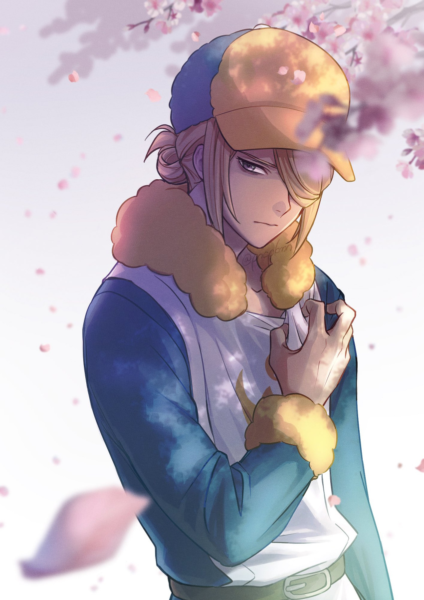 1boy belt blonde_hair blue_headwear blue_jumpsuit blurry closed_mouth clutching_chest commentary_request falling_petals fur_trim ginkgo_guild_uniform grey_eyes hair_over_one_eye hand_up hat highres jumpsuit long_sleeves male_focus petals pokemon pokemon_(game) pokemon_legends:_arceus punico_(punico_poke) short_hair solo twitter_username volo_(pokemon) watermark yellow_headwear
