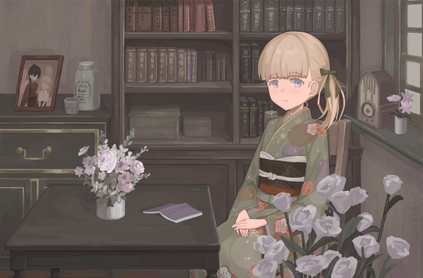 1girl alternate_costume bangs blonde_hair blue_eyes blunt_bangs book bookshelf cabinet chair floral_print flower green_kimono green_ribbon hair_ribbon hana_(pixiv74197937) highres houshou_(kancolle) indoors japanese_clothes kantai_collection kimono long_hair obi open_book photo_(object) plant potted_plant print_kimono radio ribbon sash shin'you_(kancolle) solo table white_flower