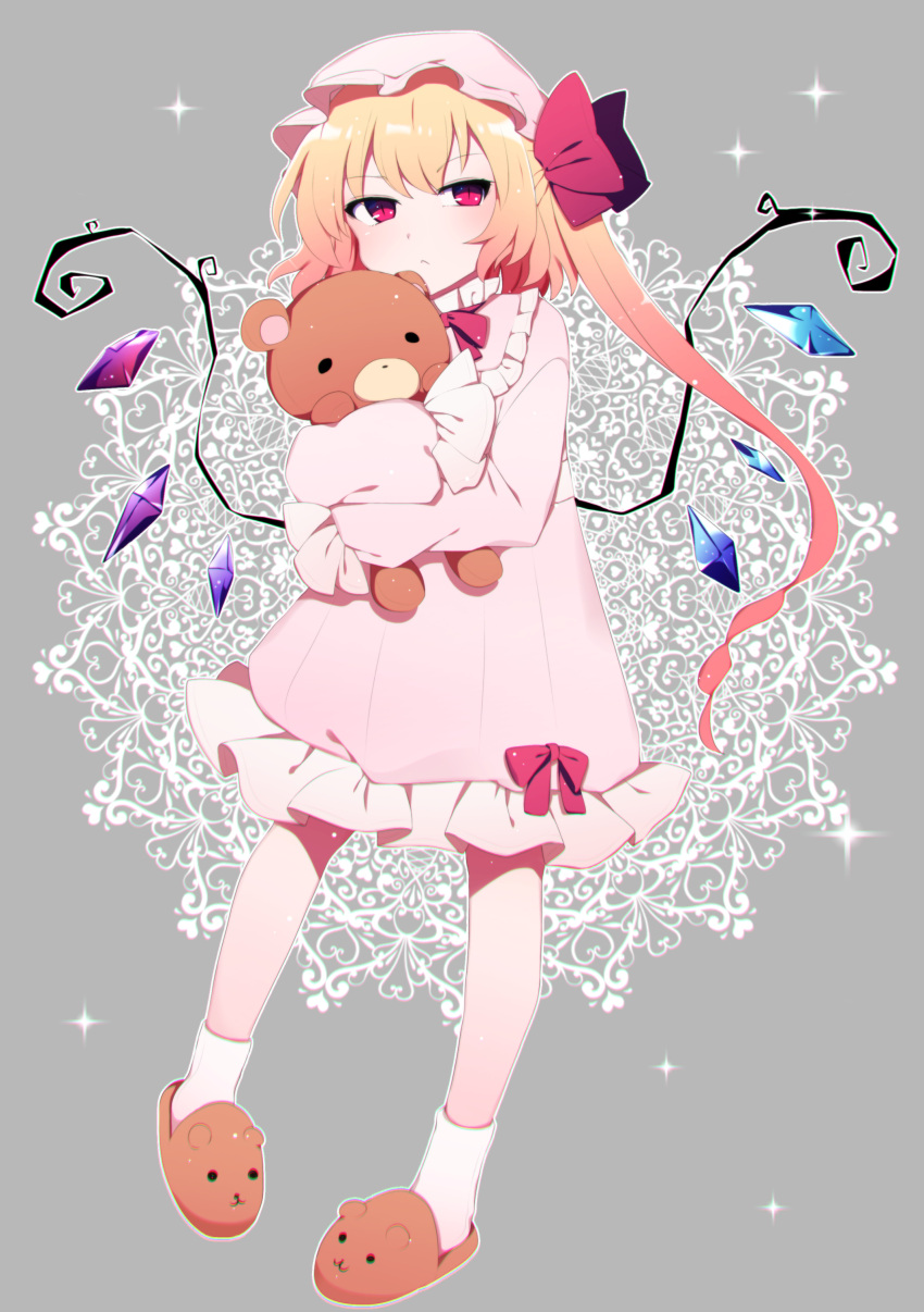 1girl :&lt; absurdres animal_slippers bangs bear_slippers blonde_hair bow closed_mouth commentary_request crystal eyebrows_visible_through_hair flandre_scarlet full_body grey_background hair_bow hat highres long_hair long_sleeves mob_cap nightgown object_hug one_side_up pink_headwear pink_nightgown red_bow red_eyes slippers slit_pupils socks solo sparkle stuffed_animal stuffed_toy teddy_bear touhou white_legwear wings you_(noanoamoemoe)
