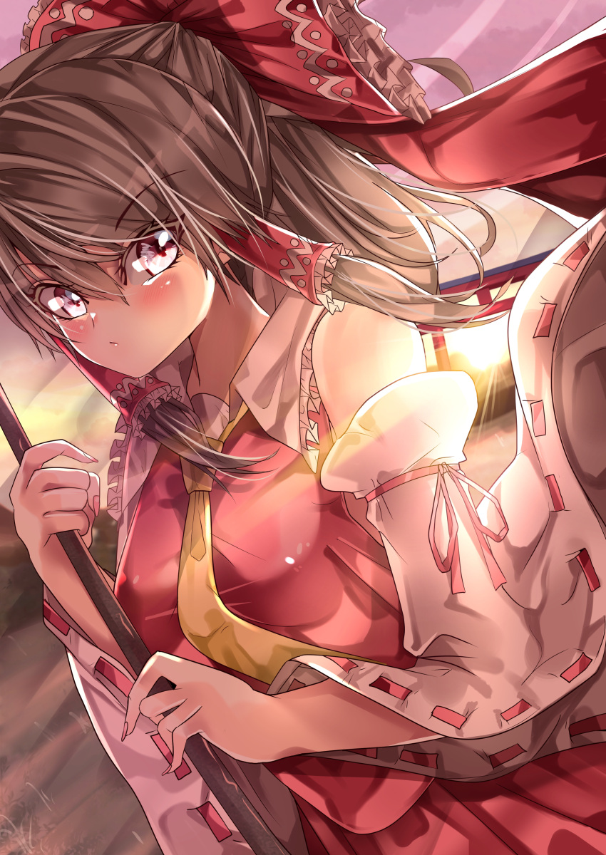 1girl absurdres bare_shoulders bow breasts brown_hair closed_mouth commentary_request detached_sleeves eyebrows_visible_through_hair frilled_bow frilled_hair_tubes frilled_shirt_collar frills hair_between_eyes hair_bow hair_tubes hakurei_reimu highres holding long_hair looking_at_viewer maboroshi_mochi nail_polish necktie outdoors pink_nails purple_sky red_bow red_ribbon red_shirt red_skirt ribbon ribbon-trimmed_sleeves ribbon_trim shirt skirt sleeveless sleeveless_shirt small_breasts solo torii touhou twilight upper_body violet_eyes wide_sleeves yellow_necktie