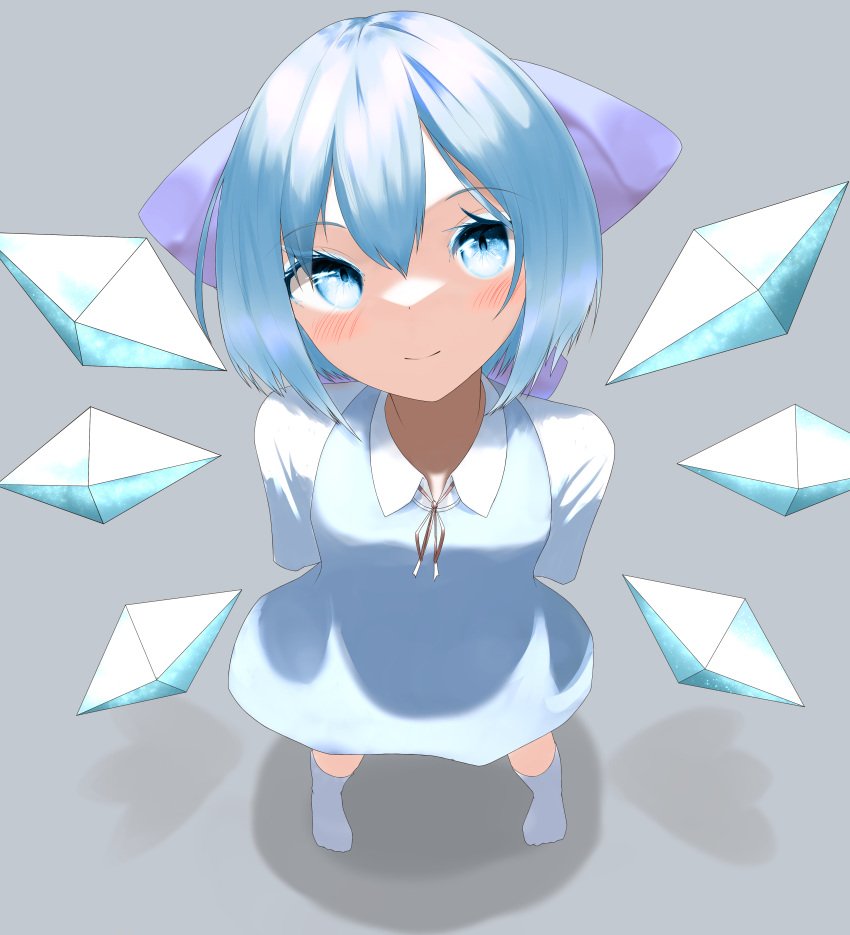 1girl absurdres arms_behind_back bangs blue_bow blue_dress blue_eyes blue_hair blush bow cirno dress fal-faaaaaaal foreshortening from_above full_body grey_background hair_between_eyes hair_bow highres ice ice_wings legs_apart light_smile looking_at_viewer looking_up puffy_sleeves red_ribbon revision ribbon shadow short_hair simple_background solo standing touhou white_legwear wings