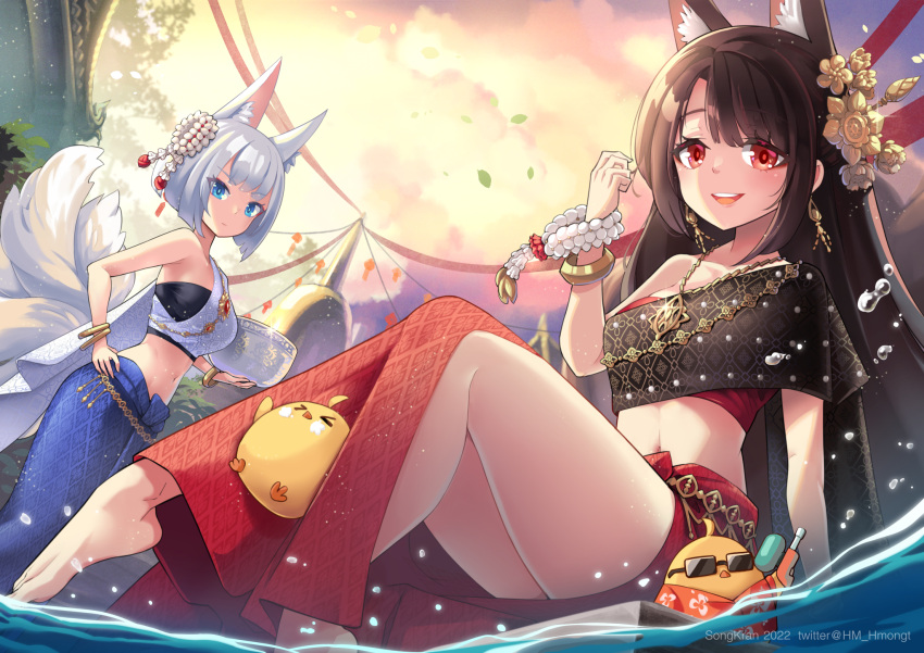 2girls akagi_(azur_lane) alternate_costume animal_ear_fluff animal_ears azur_lane barefoot english_commentary fox_ears fox_girl fox_tail hair_ornament highres hm_(hmongt) holding jewelry kaga_(azur_lane) looking_at_viewer manjuu_(azur_lane) multiple_girls necklace single_bare_shoulder smile stomach sunglasses tail thai_clothes water