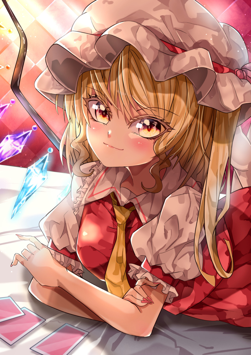 1girl absurdres blonde_hair breasts checkered_background closed_mouth collared_shirt commentary_request crystal eyebrows_visible_through_hair flandre_scarlet frilled_shirt_collar frilled_sleeves frills glowing glowing_wings hand_on_own_arm hat hat_ribbon head_tilt highres long_hair looking_at_viewer lying maboroshi_mochi mob_cap nail_polish necktie on_stomach orange_eyes pink_nails puffy_short_sleeves puffy_sleeves red_ribbon red_skirt ribbon shirt short_sleeves side_ponytail skirt skirt_set small_breasts smile solo touhou vest white_headwear white_legwear white_shirt wings yellow_necktie yellow_vest