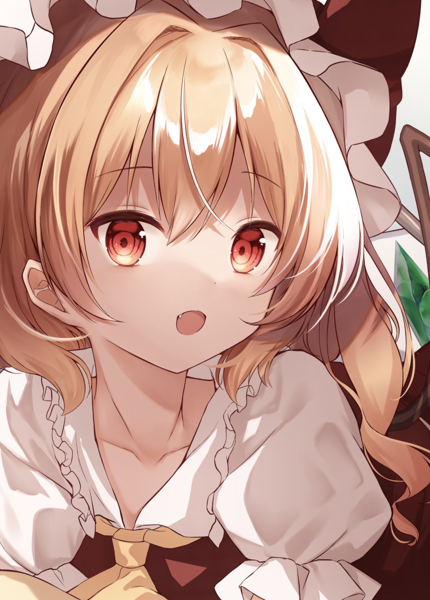 1girl ascot bangs bed blonde_hair bow collarbone collared_shirt crystal dress eyebrows_visible_through_hair fang flandre_scarlet frills grey_headwear hair_between_eyes hat hat_bow highres jewelry looking_at_viewer lying mumu-crown on_stomach one_side_up puffy_short_sleeves puffy_sleeves red_bow red_dress red_eyes shirt short_hair short_sleeves solo touhou upper_body wings yellow_ascot