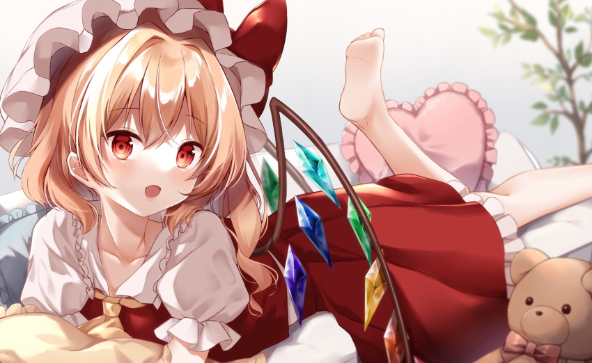 1girl ascot barefoot bed blonde_hair blush bow bowtie branch collared_shirt commentary_request crystal eyebrows_visible_through_hair flandre_scarlet frilled_pillow frilled_shirt_collar frilled_skirt frilled_sleeves frills hat heart heart_pillow highres leg_up lying medium_hair mob_cap mumu-crown on_bed on_stomach one_side_up open_mouth pillow puffy_short_sleeves puffy_sleeves red_bow red_bowtie red_eyes red_skirt red_vest shirt short_sleeves side_ponytail skirt skirt_set stuffed_animal stuffed_toy teddy_bear touhou vest white_headwear white_shirt wings yellow_ascot
