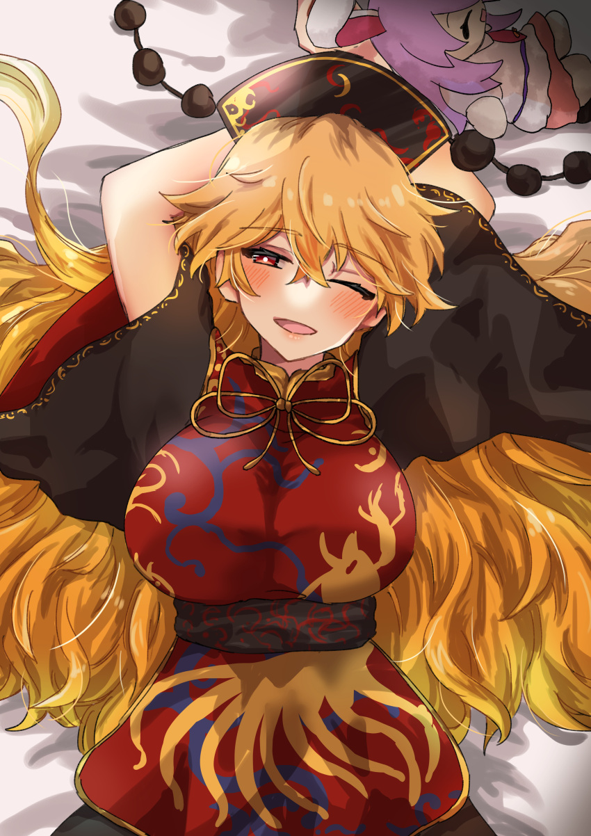 1girl ;d absurdres arms_behind_head arms_up bed_sheet black_dress blonde_hair blush breasts bright_pupils character_doll chinese_clothes dress gold_trim hara22hara hat highres junko_(touhou) large_breasts long_hair long_sleeves looking_at_viewer lying on_back on_bed one_eye_closed open_mouth red_eyes reisen_udongein_inaba sash short_sleeves smile solo tabard tassel touhou very_long_hair white_pupils wide_sleeves