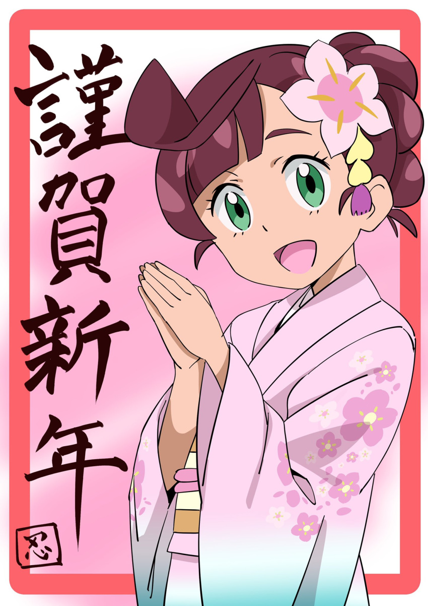 1girl :d ahoge alternate_costume bangs brown_hair chloe_(pokemon) commentary_request eyelashes floral_print flower framed green_eyes hair_flower hair_ornament hands_up highres japanese_clothes kimono looking_at_viewer new_year open_mouth own_hands_together pink_flower pink_kimono pokemon pokemon_(anime) pokemon_swsh_(anime) sash smile solo tongue translation_request upper_body wide_sleeves yusuke_oshida