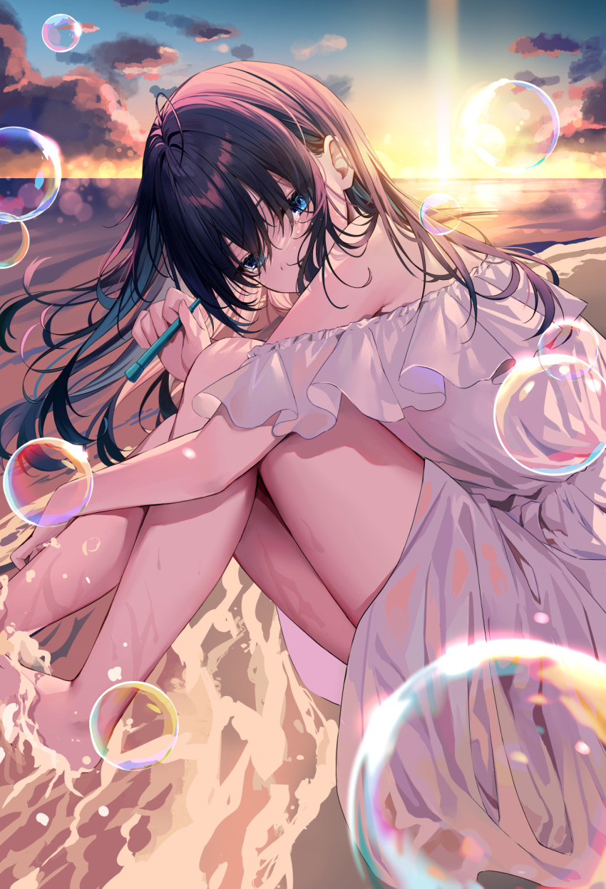 1girl bangs bare_shoulders black_hair blue_eyes bubble commentary dress english_commentary from_side highres hizuki_higure knees_up long_hair looking_at_viewer looking_to_the_side ocean off_shoulder original outdoors sitting sunlight sunset thighs water wet white_dress