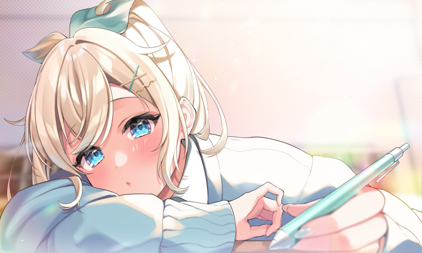 1girl absurdres anzu_1026 arm_pillow bangs blonde_hair blue_eyes blue_nails blue_sweater blurry blurry_foreground blush depth_of_field eyebrows_visible_through_hair hair_ornament hair_ribbon hairclip highres holding holding_pen hololive kazama_iroha long_sleeves looking_at_viewer nail_polish parted_lips pen ribbon sidelocks solo sweater upper_body virtual_youtuber x_hair_ornament