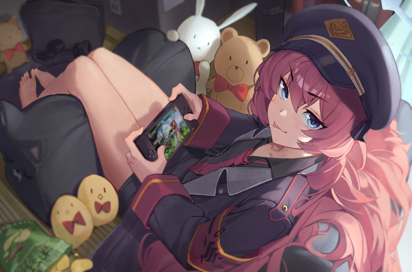 1girl :p absurdres armband bag_of_chips barefoot blue_archive chips coat food handheld_game_console hat highres indoors iroha_(blue_archive) jacket jaws_(okdol0928) military military_hat military_jacket military_uniform necktie open_clothes open_jacket peaked_cap playing_games potato_chips red_necktie redhead safety_pin sitting snack solo stuffed_animal stuffed_bunny stuffed_toy teddy_bear tongue tongue_out uniform