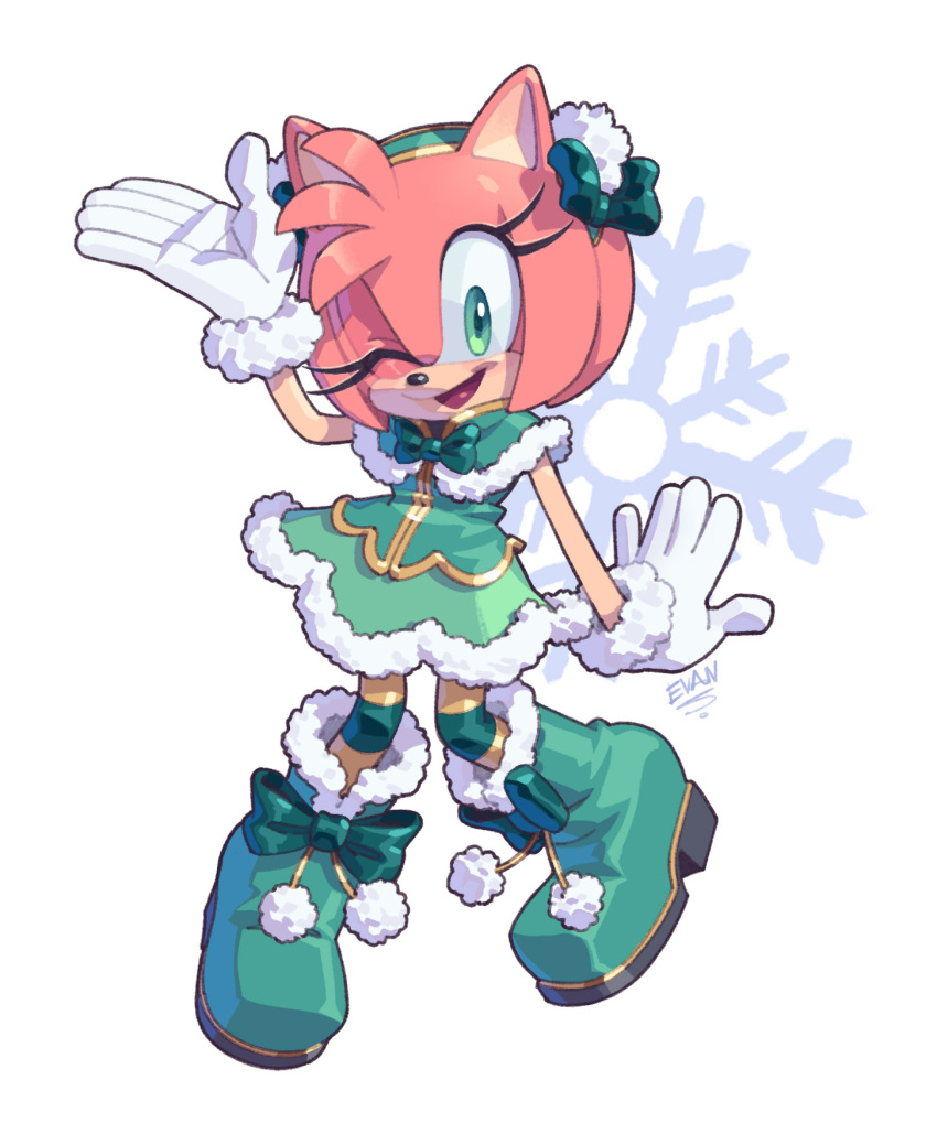 1girl amy_rose artist_name boots christmas diadem dress evan_stanley gloves green_eyes highres looking_at_viewer one_eye_closed open_mouth pink_fur ribbon sleeveless smile snowflakes solo sonic_(series) tongue