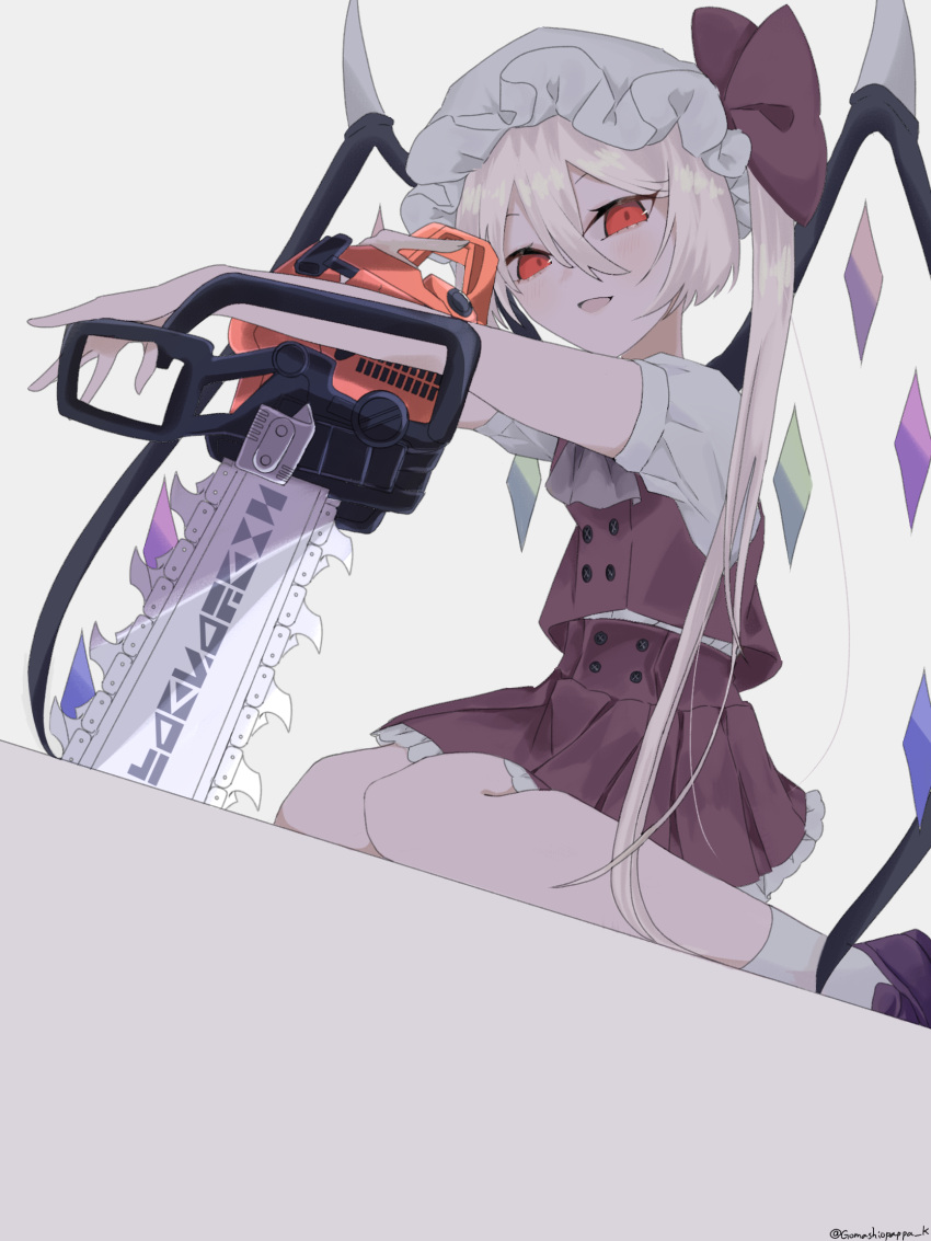 1girl ascot blonde_hair buttons chainsaw crystal flandre_scarlet frilled_skirt frills full_body gomashiopappa_k grey_ascot hair_between_eyes hat hat_ribbon highres holding holding_chainsaw long_hair looking_at_viewer mob_cap one_side_up open_mouth purple_footwear red_eyes red_ribbon red_skirt red_vest ribbon seiza shirt shoes short_sleeves sidelocks sitting skirt socks solo touhou twitter_username vest white_headwear white_legwear white_shirt wings