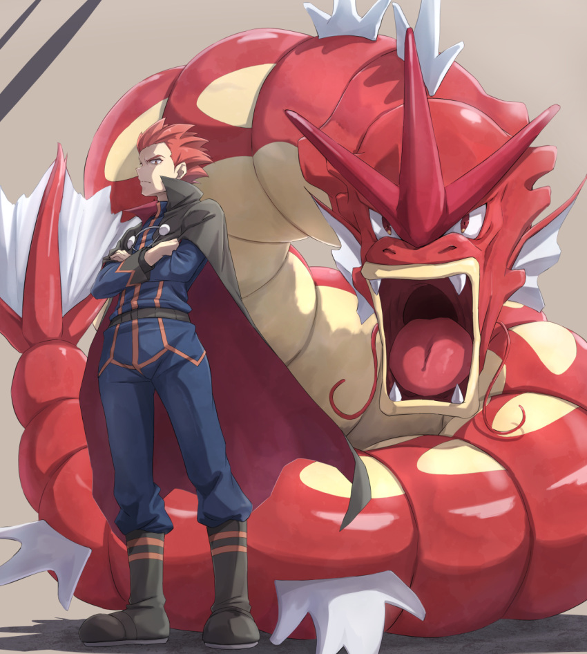 1boy alternate_color belt boots cape closed_mouth commentary_request crossed_arms frown gyarados highres itsudzumi jacket lance_(pokemon) long_sleeves male_focus pants pokemon pokemon_(game) pokemon_hgss redhead shiny_pokemon short_hair spiky_hair standing