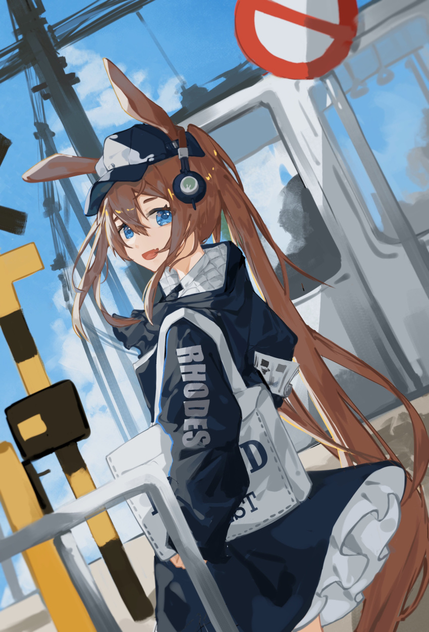 1girl :d absurdres amiya_(arknights) amiya_(newsgirl)_(arknights) animal_ears arknights ascot bag baseball_cap black_ascot black_coat black_headwear blue_eyes blue_sky brown_hair clothes_writing coat cowboy_shot day extra_ears frills from_behind ground_vehicle hat headphones highres long_hair long_sleeves looking_at_viewer looking_back official_alternate_costume okiautumn open_mouth outdoors ponytail rabbit_ears road_sign shoulder_bag sign sky smile solo train very_long_hair