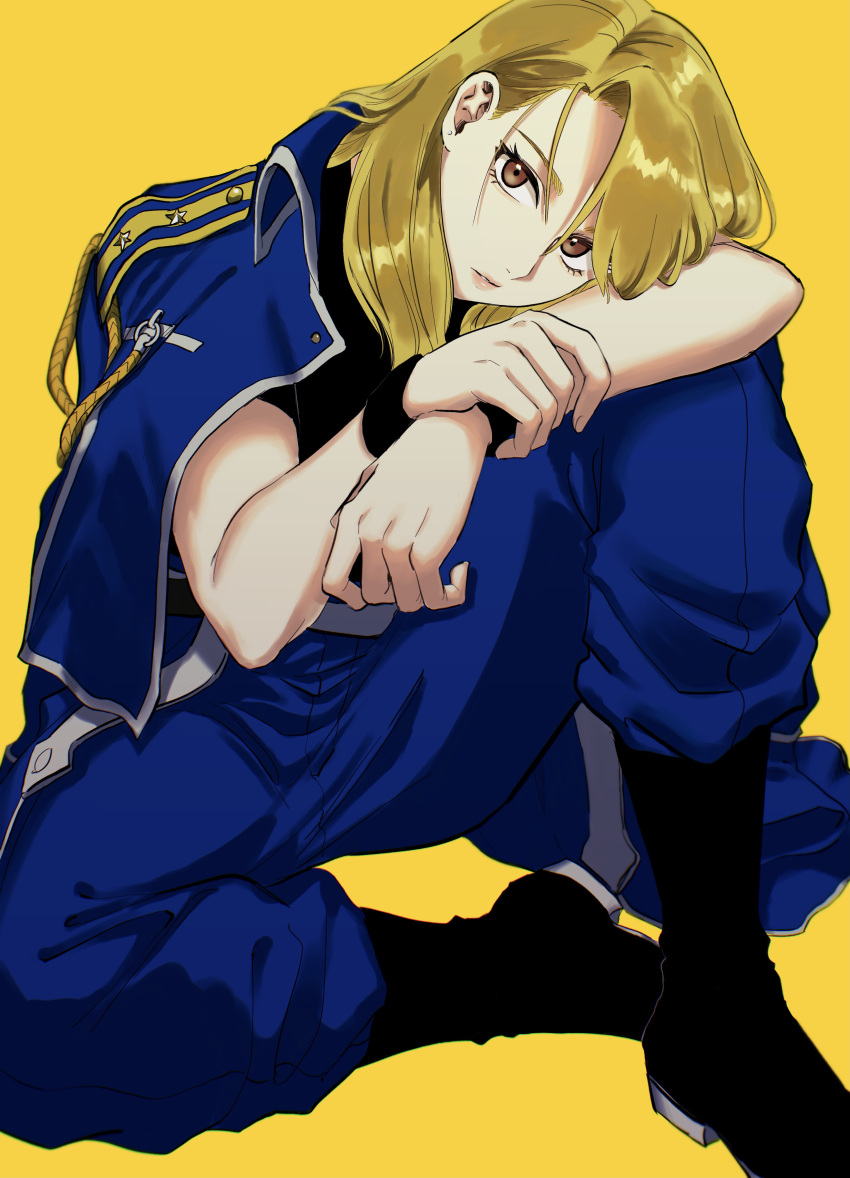1girl absurdres aiguillette arm_on_knee arm_pillow black_footwear black_shirt blonde_hair blue_jacket blue_pants boots brown_eyes eyelashes fullmetal_alchemist hair_between_eyes hand_on_own_arm head_rest highres jacket jacket_on_shoulders jewelry knee_up long_hair looking_at_viewer military military_uniform ozaki_(tsukiko3) pants pants_tucked_in parted_lips riza_hawkeye shirt short_sleeves simple_background sitting solo star_(symbol) uniform wristband yellow_background