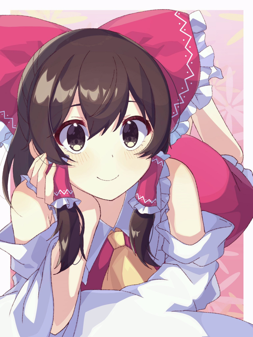1girl ascot bangs bare_shoulders blush border bow brown_eyes brown_hair closed_mouth collared_dress commentary_request detached_sleeves dress eyebrows_visible_through_hair floral_background flower frills gradient gradient_background hair_between_eyes hair_ornament hair_tubes hakurei_reimu hand_on_own_face hand_up highres kudamono25253 legs_up long_sleeves lying on_stomach orange_flower outside_border pink_background pink_bow pink_dress pink_flower short_hair smile solo touhou white_border wide_sleeves yellow_ascot yellow_flower