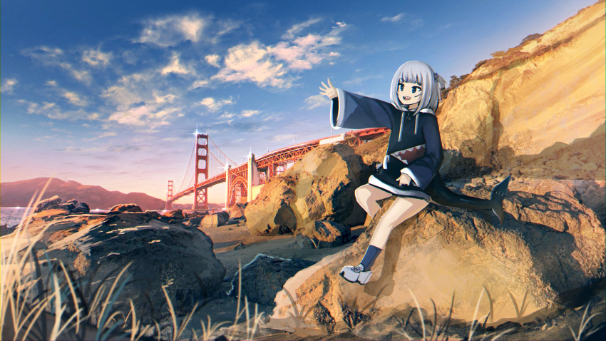 1girl :d absurdres anonamos bangs blue_eyes blue_hair blue_hoodie blue_legwear blue_sky blunt_bangs bridge clouds commentary drawstring english_commentary fish_tail gawr_gura golden_gate_bridge grass hair_ornament highres hololive hololive_english hood hood_down hoodie long_sleeves looking_to_the_side mountain mountainous_horizon multicolored_hair ocean outdoors rock san_francisco shark_girl shark_hair_ornament shark_tail sharp_teeth sitting sky smile socks solo streaked_hair tail teeth virtual_youtuber white_footwear wide_sleeves