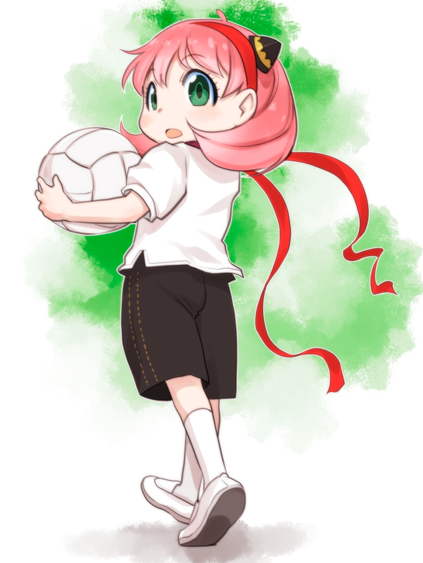 1girl anya_(spy_x_family) ball black_shorts female_child green_eyes hair_ornament hairband highres holding holding_ball looking_at_viewer looking_back open_mouth pink_hair red_hairband shirt shoes short_hair short_sleeves shorts socks solo spy_x_family t-shirt teruki_kuma walking white_background white_footwear white_shirt