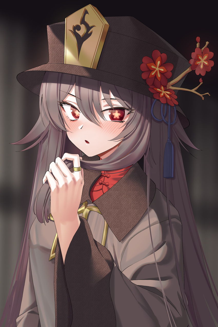 1girl absurdres bangs black_hair black_headwear blurry blurry_background blush brown_jacket commentary_request depth_of_field flower flower-shaped_pupils genshin_impact goback hair_between_eyes hand_up hat hat_flower highres hu_tao_(genshin_impact) jacket jewelry long_hair long_sleeves looking_at_viewer parted_lips red_eyes red_flower red_shirt ring shirt solo symbol-shaped_pupils upper_body very_long_hair wide_sleeves