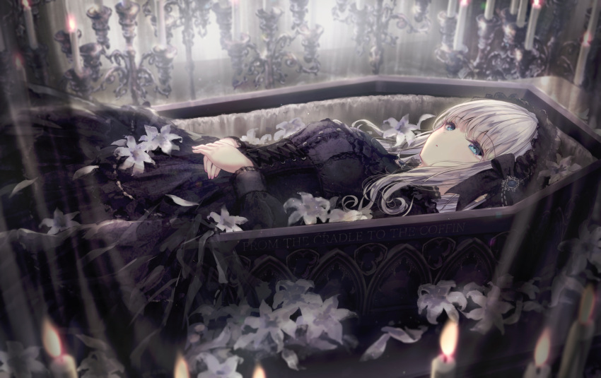 1girl bangs black_dress blue_eyes blurry blurry_background candle candlestand coffin commentary_request depth_of_field dress flower grey_hair highres lily_(flower) lolita_fashion long_hair long_sleeves lying missile228 on_back original own_hands_together parted_lips petals solo white_flower