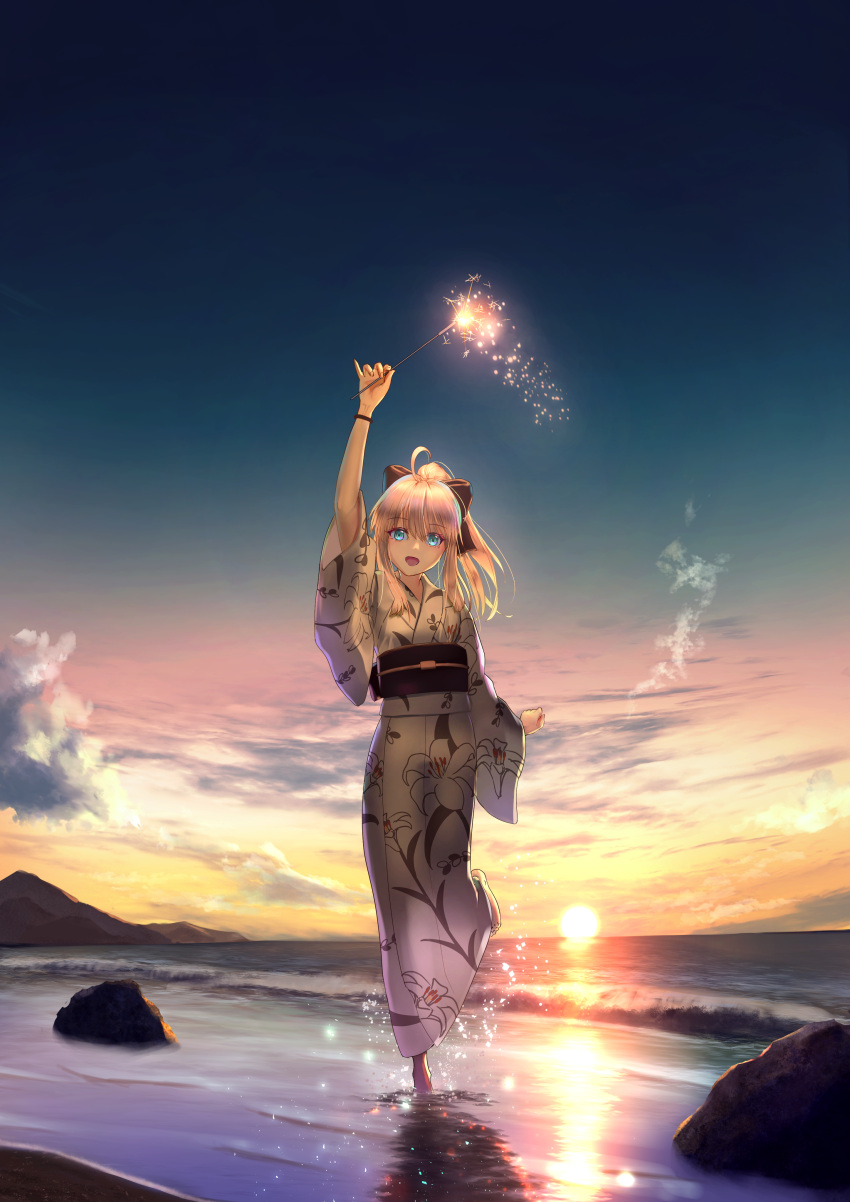 1girl absurdres ahoge aomaru_(shta-chu-jisuiai) artoria_pendragon_(fate) beach black_bow blonde_hair blue_eyes bow evening fate/grand_order fate_(series) fireworks floral_print full_body hair_bow highres holding_fireworks japanese_clothes kimono medium_hair obi ponytail print_kimono saber_lily sash solo sparkler standing white_kimono wide_sleeves yukata