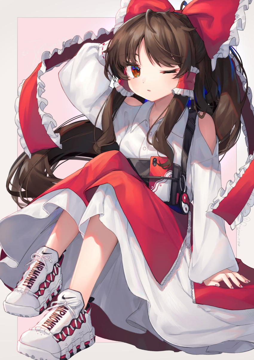 1girl ;o alternate_costume arm_behind_head bangs blush bow brown_eyes brown_hair cellphone charm_(object) clothing_cutout collared_dress collared_shirt commentary_request contemporary dress frilled_bow frilled_hair_tubes frills full_body gunjou_row hair_bow hair_tubes hakurei_reimu highres long_hair long_sleeves looking_at_viewer nail_polish nike one_eye_closed open_mouth phone product_placement red_bow red_nails shirt shoes shoulder_cutout sitting smartphone sneakers solo touhou white_dress white_footwear yin_yang zipper zipper_skirt