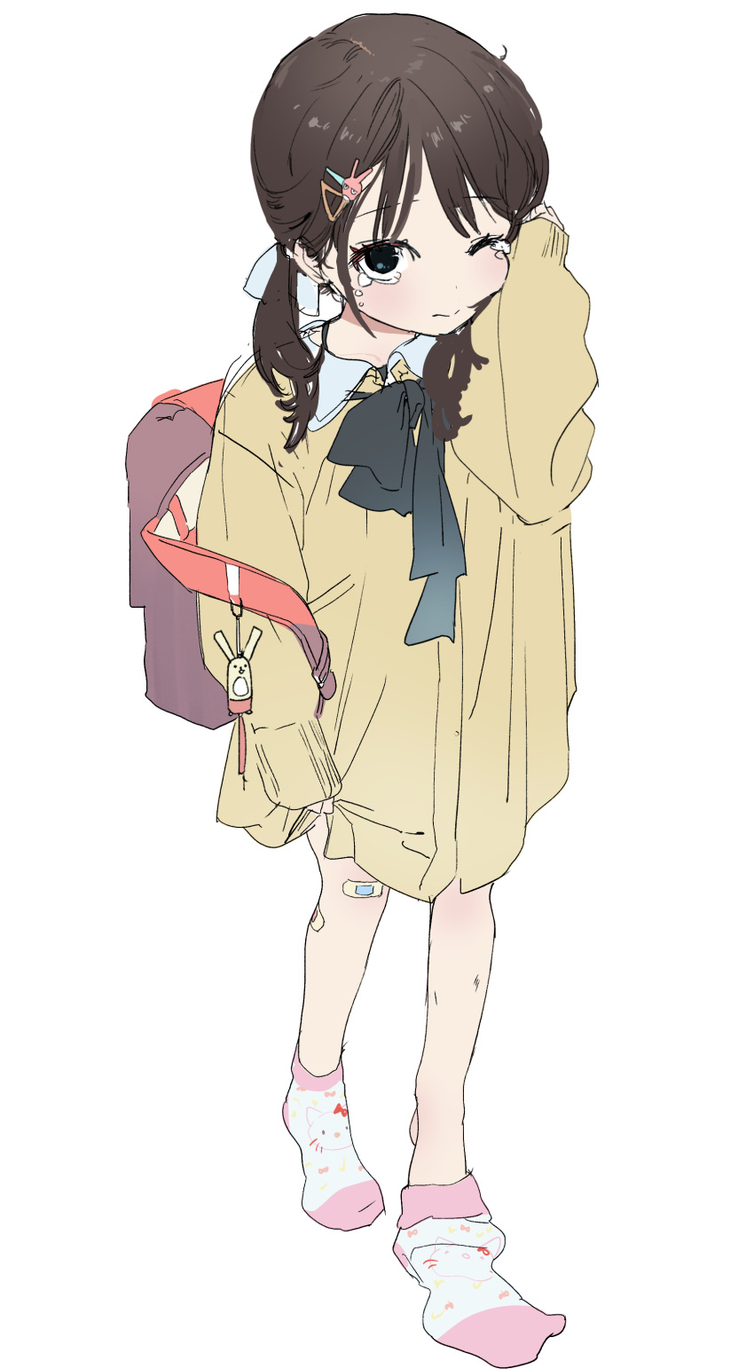 1girl ;| absurdres backpack bag bandaid bandaid_on_leg black_hair dorontabi dress female_child highres looking_at_viewer neck_ribbon no_shoes original randoseru removing_sock ribbon simple_background sleeves_past_wrists socks solo tears twintails white_background yellow_dress