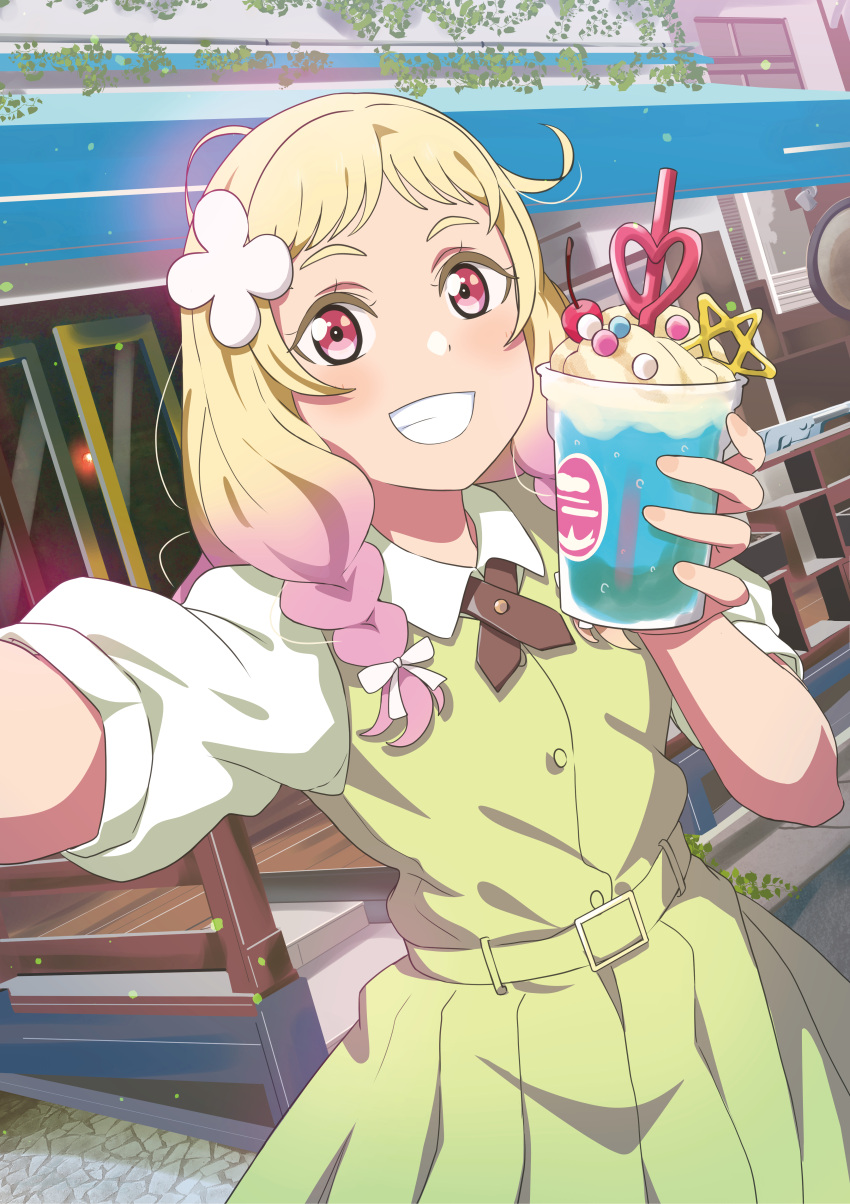 1girl absurdres al_aoi_aoba bangs belt_buckle birthday blonde_hair blush braid buckle commentary dress drink flower gradient_hair green_dress grin hair_flower hair_ornament highres holding holding_drink long_hair looking_at_viewer love_live! love_live!_superstar!! multicolored_hair onitsuka_natsumi pink_eyes pink_hair selfie short_sleeves smile solo twin_braids upper_body