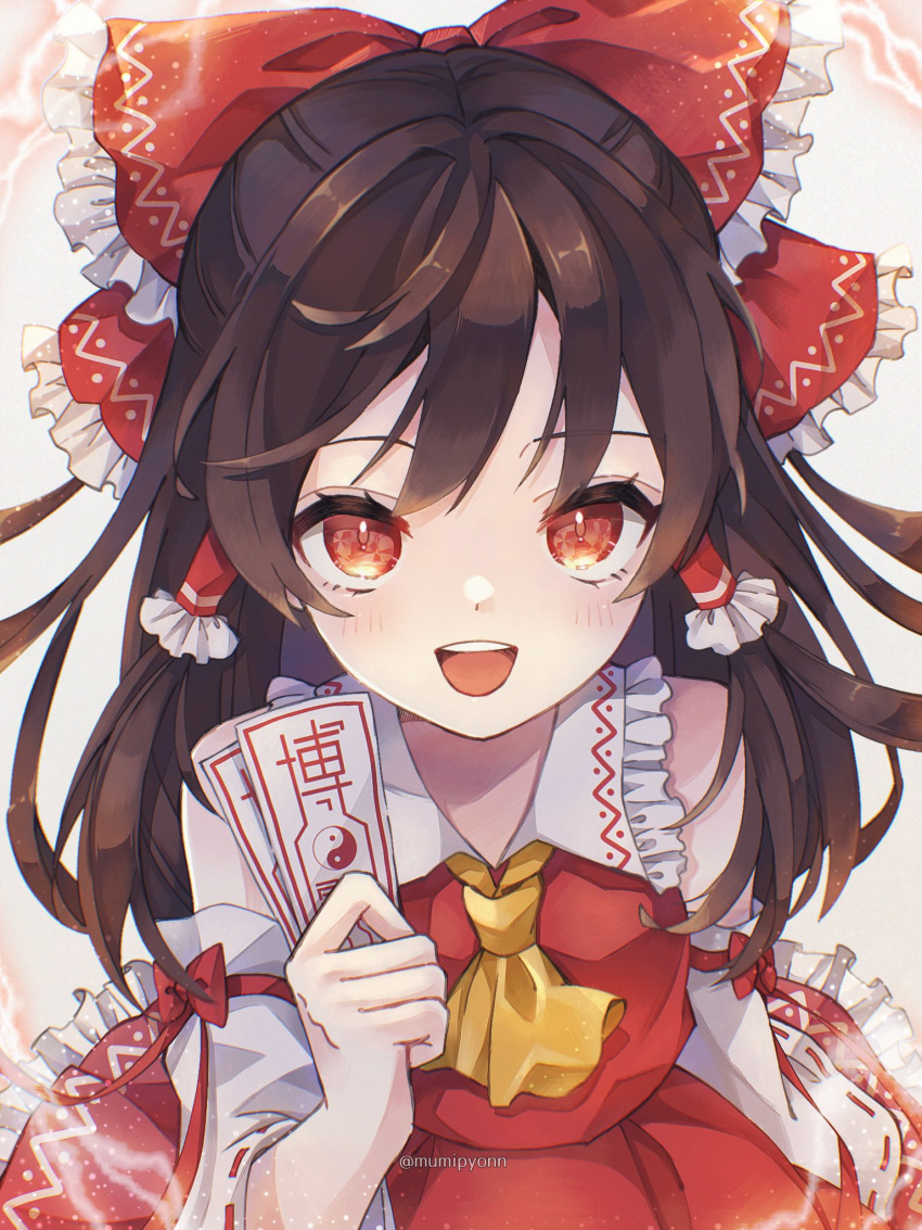 1girl :d ascot bangs blush bow brown_hair collared_vest commentary_request detached_sleeves frilled_bow frilled_hair_tubes frilled_shirt_collar frilled_skirt frills from_above hair_bow hair_tubes hakurei_reimu highres holding long_hair looking_at_viewer mumipyonn ofuda open_mouth red_bow red_eyes red_skirt red_vest skirt smile solo teeth touhou twitter_username upper_teeth vest white_sleeves yellow_ascot yin_yang