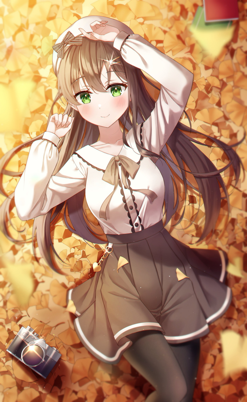 1girl absurdres arm_up autumn autumn_leaves bangs beret bingyam black_pantyhose blurry blurry_foreground blush book bow brown_bow brown_hair brown_ribbon brown_skirt buttons camera casual closed_mouth collared_shirt commentary depth_of_field eyelashes falling_leaves ginkgo_leaf glint green_eyes hair_between_eyes hair_ornament hairclip hand_up hat hat_bow highres leaf long_hair long_sleeves looking_at_viewer lying neck_ribbon on_back original pantyhose pleated_skirt ribbon shirt shirt_tucked_in sidelocks skirt smile solo striped striped_bow symbol-only_commentary white_headwear white_shirt