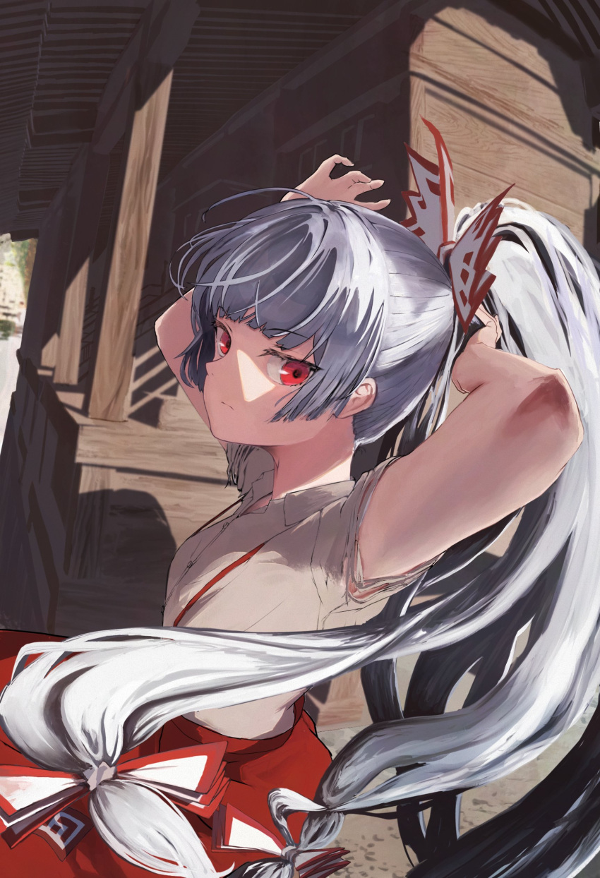 1girl absurdres adjusting_hair arms_up bangs blunt_bangs bow building closed_mouth collared_shirt commentary cowboy_shot foreshortening fujiwara_no_mokou grey_hair grey_shirt hair_bow hand_on_own_head highres long_hair looking_at_viewer pants ponytail red_bow red_eyes red_pants shirt sideways_glance solo suspenders torn_clothes torn_sleeves touhou tsukechi two-tone_bow white_bow