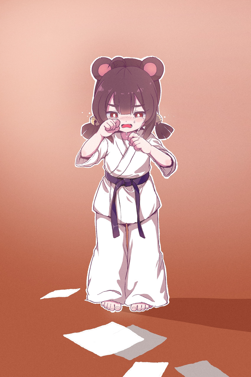 1girl absurdres animal_ears barefoot bell belt black_belt blush brown_hair child chinese_commentary clenched_hands commentary_request crying dougi hair_bell hair_between_eyes hair_ornament half-closed_eyes hands_up highres karate karate_gi kuma-bound nose_blush open_mouth orange_background original pants paper red_eyes short_sleeves short_twintails solo standing toes twintails white_pants