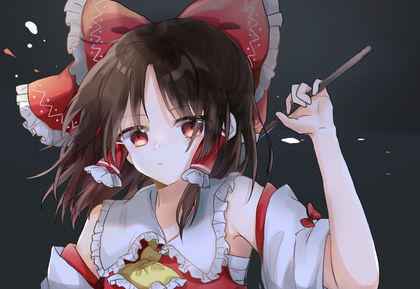 1girl ascot bangs blush bow brown_hair closed_mouth collar commentary_request detached_sleeves frilled_collar frills gohei hair_bow hakurei_reimu highres long_sleeves looking_at_viewer red_bow red_eyes red_vest sarashi shinonome_(ichigotsuki) solo touhou vest wide_sleeves yellow_ascot