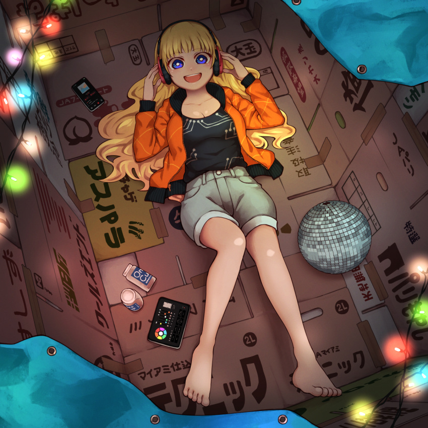 1girl :d barefoot blonde_hair blue_eyes box bright_pupils cardboard cardboard_box cellphone christmas_lights commentary disco_ball headphones highres looking_at_viewer lying on_back one_cup original phone short_shorts shorts smartphone smile solo tarpaulin white_pupils yajirushi_(chanoma)