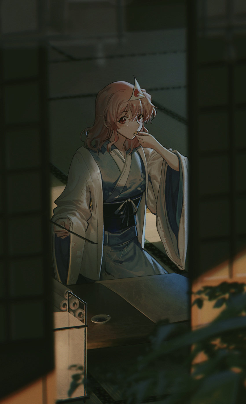 1girl absurdres blue_kimono blurry blurry_background calligraphy_brush chabudai_(table) commentary_request e_(you33ou) eating highres holding holding_brush indoors japanese_clothes kimono long_sleeves looking_at_viewer medium_hair no_headwear obi open_clothes open_shirt paintbrush paper pink_hair plant red_eyes saigyouji_yuyuko sash scroll seiza shirt sitting sliding_doors solo table tatami touhou triangular_headpiece white_shirt wide_sleeves