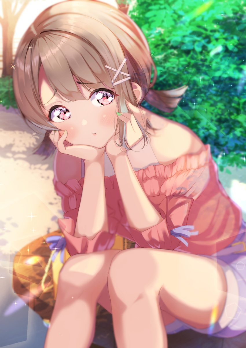 1girl absurdres blush commentary day furrowed_brow green_nails hair_ornament hairclip hands_on_own_cheeks hands_on_own_face head_rest highres lens_flare light_brown_hair looking_at_viewer love_live! love_live!_nijigasaki_high_school_idol_club low_twintails medium_hair nail_polish nakasu_kasumi off-shoulder_shirt off_shoulder outdoors parted_lips pink_eyes pink_shirt shirt short_twintails shorts sitting solo sophiaenju twintails
