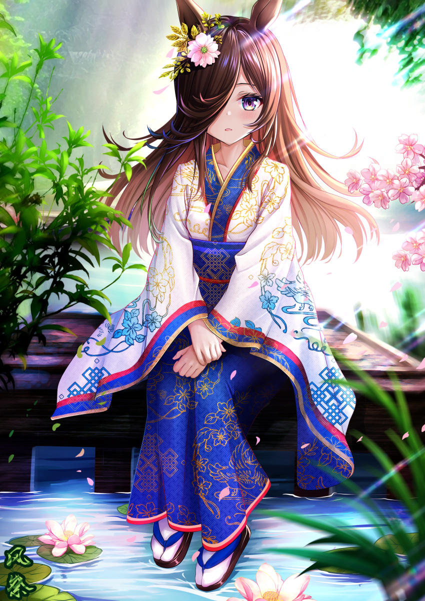 1girl absurdres alternate_costume animal_ears bangs blue_kimono brown_footwear brown_hair cherry_blossoms collarbone commentary_request day floating_hair flower full_body hair_flower hair_ornament hair_over_one_eye highres horse_ears japanese_clothes kazamatsuri_honatsu kimono light_rays long_hair long_sleeves looking_at_viewer lotus outdoors parted_lips petals pink_flower plant rice_shower_(umamusume) sandals sitting socks solo two-tone_kimono umamusume violet_eyes water white_kimono white_socks wide_sleeves