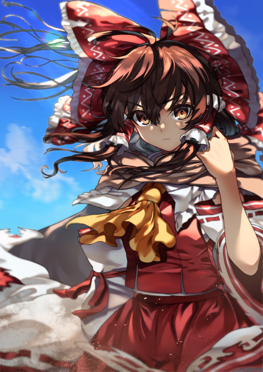 1girl ascot bangs blue_sky bow brown_eyes brown_hair closed_mouth clouds commentary_request cowboy_shot creeper_(gametime) day detached_sleeves dust frilled_bow frilled_hair_tubes frills hair_between_eyes hair_bow hair_tubes hakurei_reimu hand_up highres long_hair looking_at_viewer outdoors red_bow red_skirt red_vest ribbon-trimmed_sleeves ribbon_trim scarf skirt sky solo touhou vest white_sleeves yellow_ascot