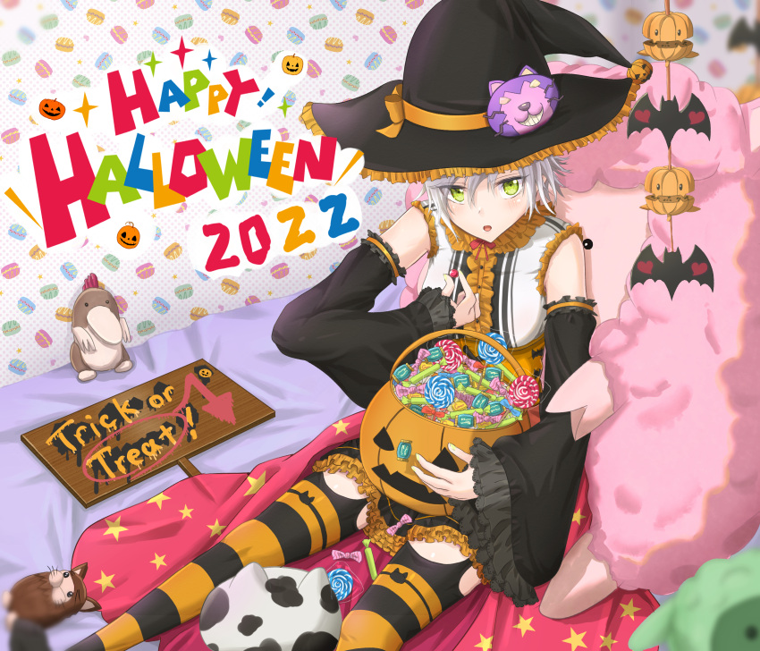 1girl bat_(animal) bed blush candy cosplay detached_sleeves eiyuu_densetsu fie_claussell food green_eyes hat highres jack-o'-lantern lollipop sen_no_kiseki short_hair sitting solo stuffed_animal stuffed_toy thigh-highs white_hair witch witch_f witch_hat