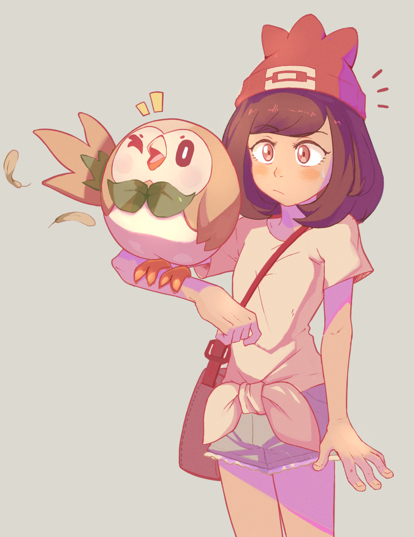 1girl absurdres bag bangs beanie bird blush brown_bag brown_hair closed_mouth feathers gen_7_pokemon gradient gradient_background green_shorts hat highres medium_hair mizuki_(pokemon) notice_lines pokemon pokemon_(creature) pokemon_(game) pokemon_on_arm pokemon_sm red_headwear rowlet sally_(luna-arts) selene_(pokemon) shirt short_shorts short_sleeves shorts shoulder_bag starter_pokemon t-shirt tied_shirt